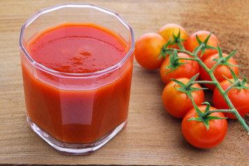 Tomato juice and  cherry tomatoes on the vine