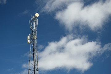 Telecommunication tower with blue sky and clouds