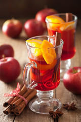 glass of mulled wine with orange and spices, christmas decoratio