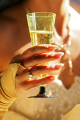 Bride is holding a glass of champagne