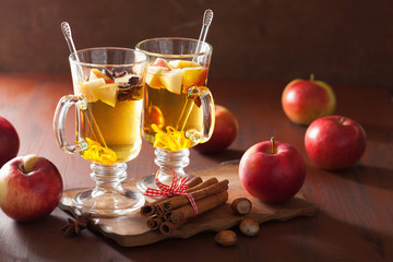 glass of mulled apple cider with  orange and spices, winter drin