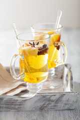 glass of mulled apple cider with  orange and spices, winter drin