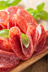 salami slices in wooden plate