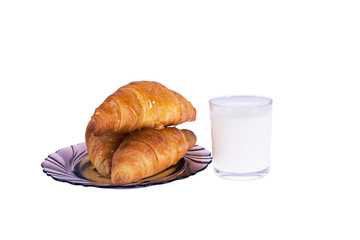 Croissants on a plate with bottle milk