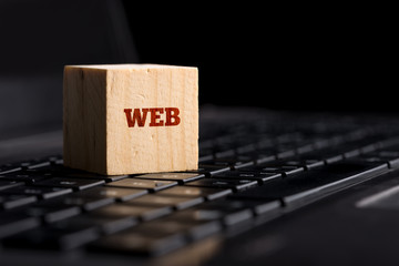 Web on Wooden Block Above Keyboard