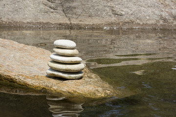 Fototapeta na wymiar Stones stacked up at the river