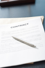 contract papers on wooden desk