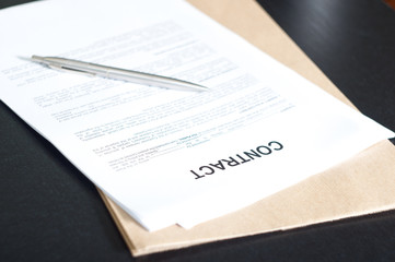 contract papers on wooden desk