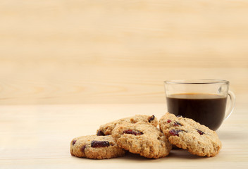 Cookies with coffee on wooden background with free text space.