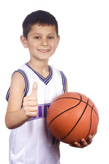 Smiling young boy holding his basketball