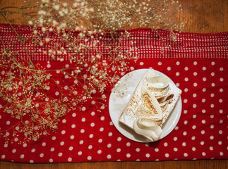 Tiramisu cake on creative background with white polka dots