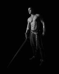 half-naked man with a sword in medieval clothes