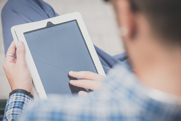 close up hands man using tablet on the bench