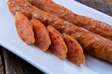 Chinese Pork Sausages in plate on wooden table