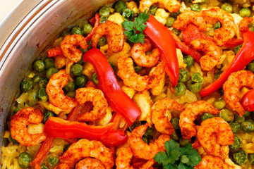 paella with shrimps and red paper, close-up