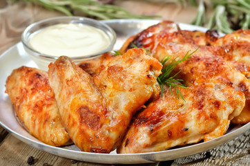 Fried chicken wings with sauce, close up view