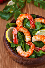Salad with fried royal shrimps and lemon