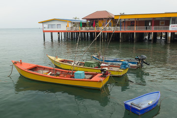 Wooden boats at pier at the sea in the afternoon