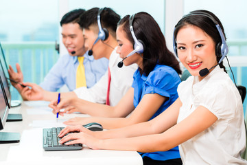 Asian Chinese call center agent team on phone