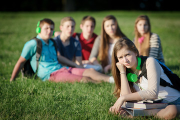 Fototapeta na wymiar Lonely Teen with Group