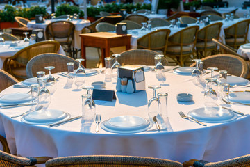 round outdoor tables covered for guests
