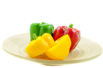 three fresh sweet pepper on wood bowl on white background
