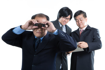 Businessman manager holding binoculars for check this stock