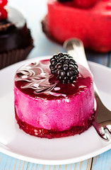 Souffle, cake berry, jelly on the wooden blue background