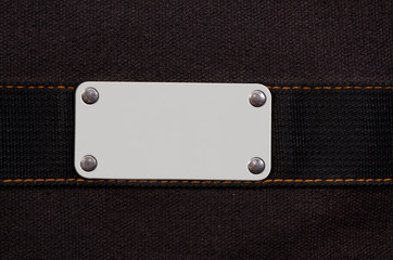 closeup of blank white grungy artificial leather label