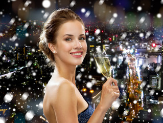 smiling woman holding glass of sparkling wine