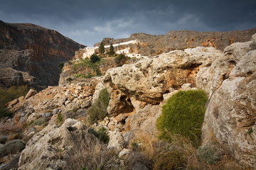 Fototapeta na wymiar Monastery and a gorge in mountains of Crete, Greece.