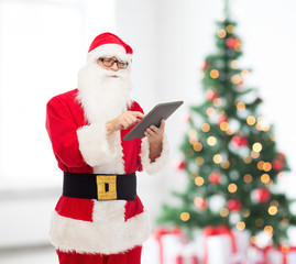 man in costume of santa claus with tablet pc