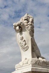 Pisa white statue of a lion near Arno river