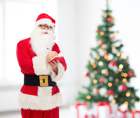 man in costume of santa claus with notepad