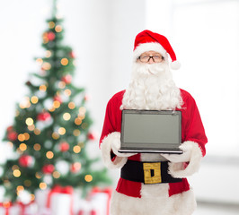 man in costume of santa claus with laptop