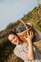 Female Carrying Basket Full Of Grapes