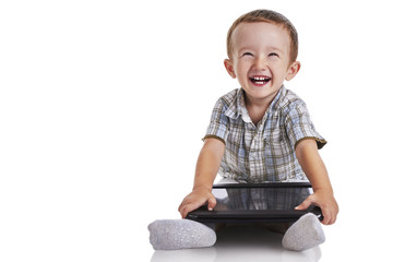 Baby toddler smilling and holding a digital tablet