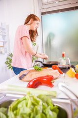 Young Housewife In The Kitchen