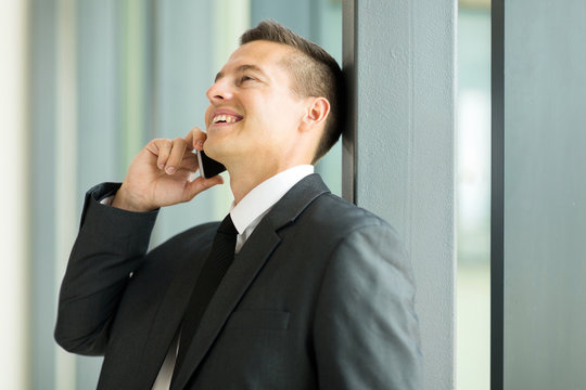 businessman talking on mobile phone in office