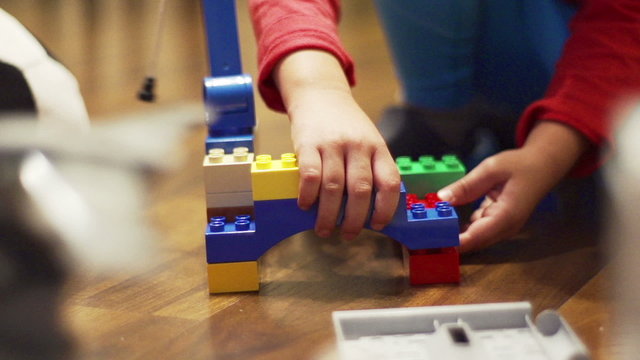 Child playing with blocks, closeup, steadycam shot, slow motion 