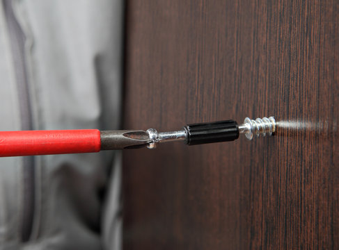 screw wrapped in wooden plank close up