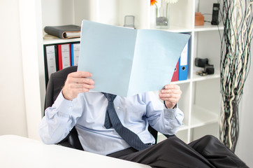 Relaxed businessman analyzing a document