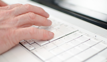 Hand typing on a keyboard