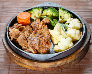 Juicy grilled pork chop (neck cut) with vegetables