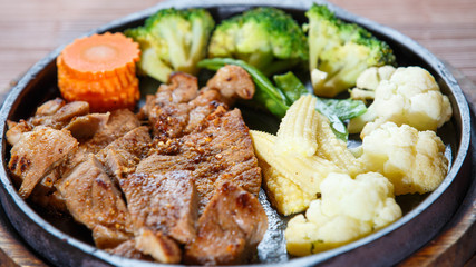 Juicy grilled pork chop (neck cut) with vegetables