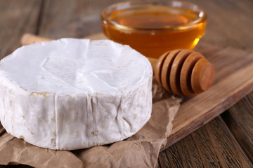 Camembert cheese and honey in glass bowl © Africa Studio