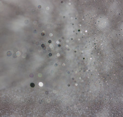 dark glitter vintage lights background. light silver and black. 