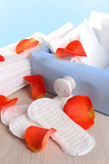 Sanitary pads in box and rose petals