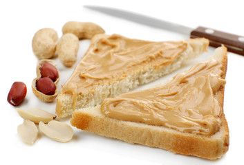 Slices of bread with creamy peanut butter, isolated on white