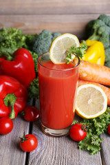 Tomato juice in glass and fresh vegetables